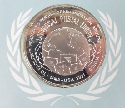 a picture of a coin or medal from the universal postal union sterling silver
