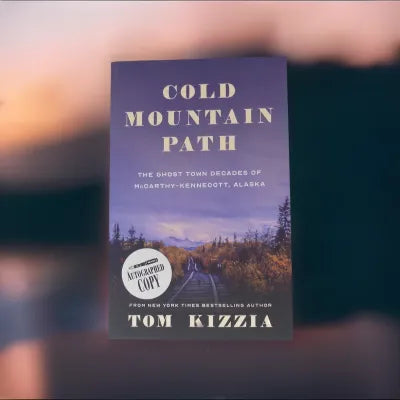 Autographed copy of Tom Kizzia's Cold Mountain Path Book, featuring a snowy mountain landscape with a winding path, signed by the author